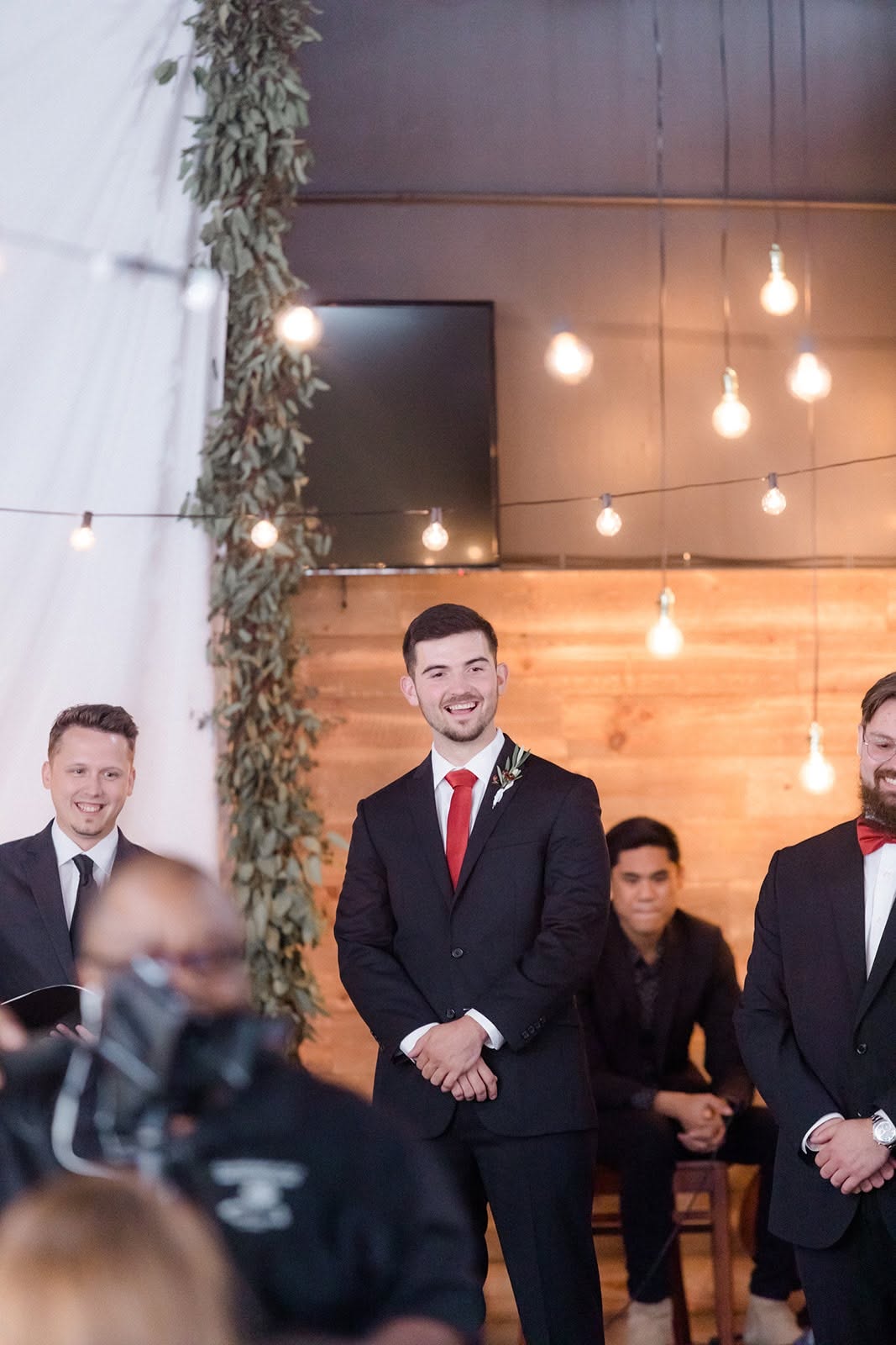 Groom smiling as Derrick leads the wedding ceremony